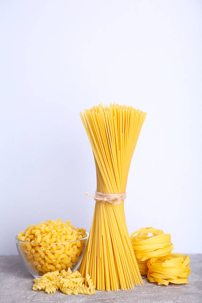 Delicious mixed pasta on grey background with copy space - Fotografie, Obrázek