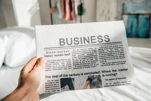 cropped view of man holding business newspaper  - Photo, image