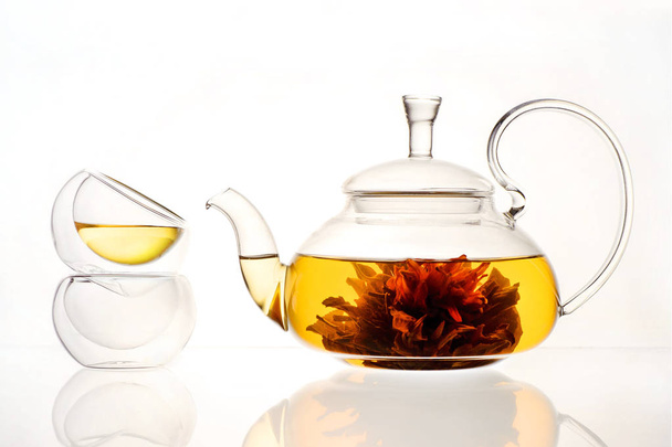 brewed tea flower in a glass teapot on a white background - Foto, Imagen