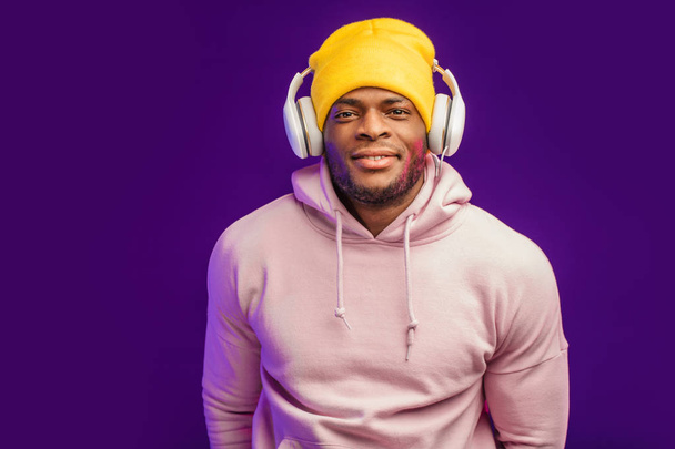 African man in hoodie with headphones isolated, happy expression. Music, people - Fotó, kép