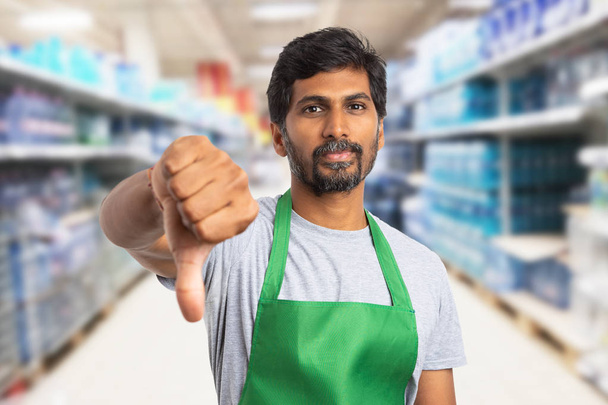 Hypermarket employee showing dislike gesture - Photo, Image