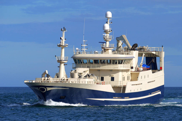 Fishing vessel underway at sea heading to fishing grounds. - Photo, Image