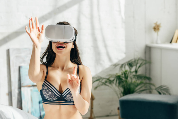 cheerful brunette woman in underwear wearing virtual reality headset  - Фото, изображение