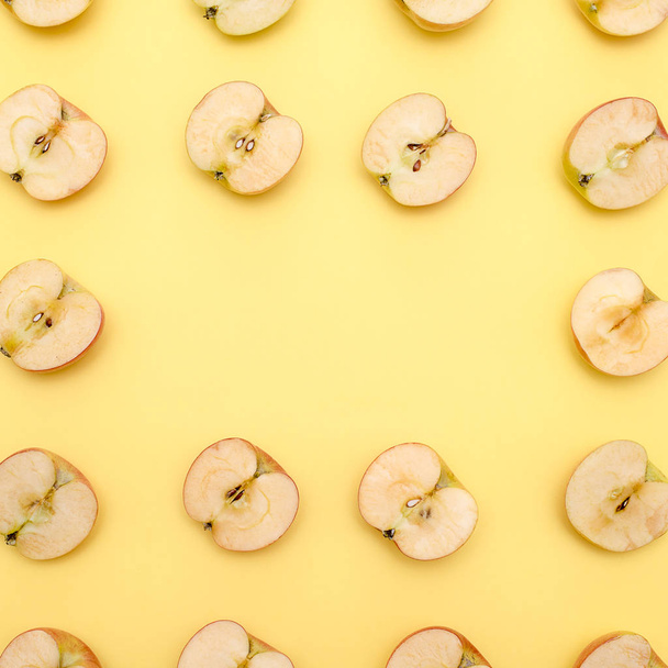 Background of cut in half apples on yellow background - Φωτογραφία, εικόνα