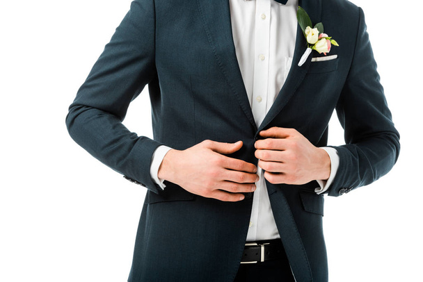 cropped view of bridegroom in elegant black suit with boutonniere isolated on white - Foto, imagen