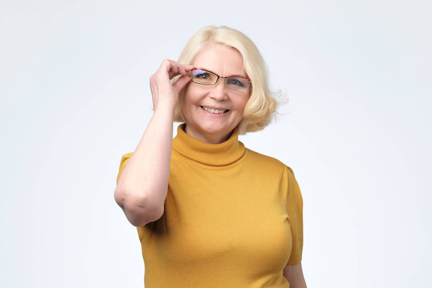 Smiling attractive senior businesswoman wearing glasses head shot - Photo, Image