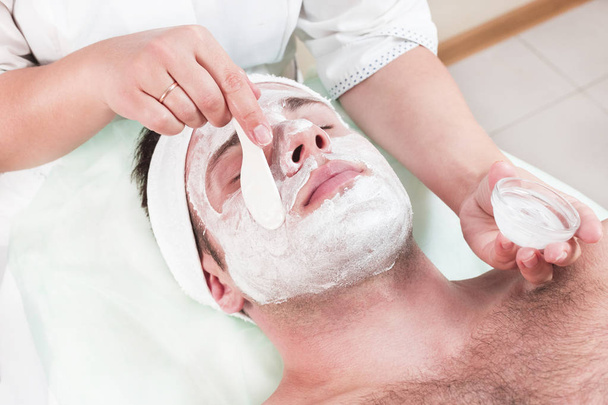 Man in the mask cosmetic procedure in spa salon  - Fotó, kép