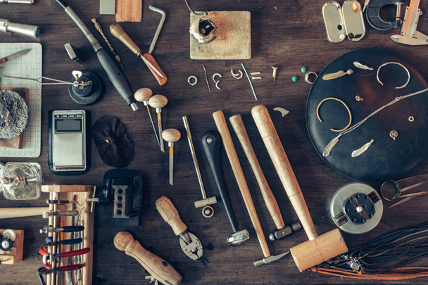 table is full of tools for making, repairing adornmnet - 写真・画像