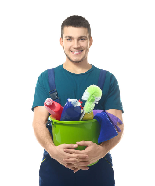 Young man with cleaning supplies on white background - Φωτογραφία, εικόνα