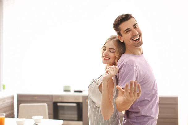Cute young couple dancing indoors - Photo, Image