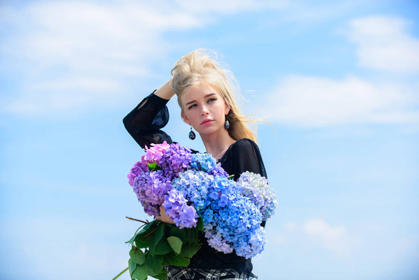 Girl tender blonde hold hydrangea bouquet. Skin care and beauty treatment. Gentle flowers for delicate woman. Pure beauty. Tenderness of young skin. Springtime bloom. Beauty of spring season - Foto, immagini