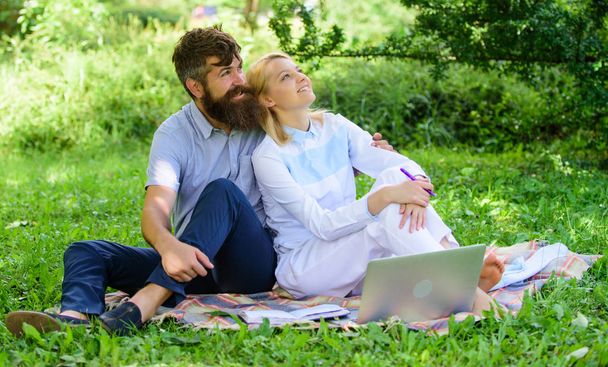 Couple in love or family work freelance. Modern online business. Freelance life benefit concept. Couple youth spend leisure outdoors working with laptop. How to balance freelance and family life - Valokuva, kuva