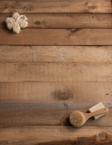 bath soap and loofah brush on wooden table - Фото, зображення
