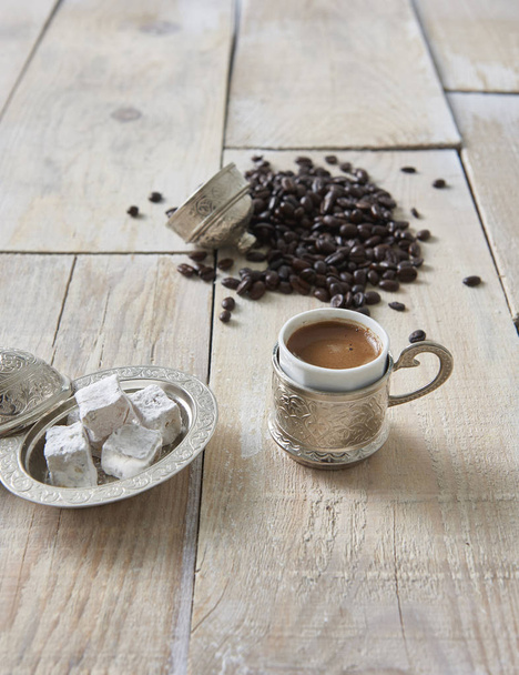 wooden table and cup of coffee with food in the background - Photo, Image