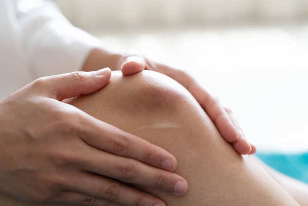 bruised knee of asia woman, selective focus - Fotó, kép