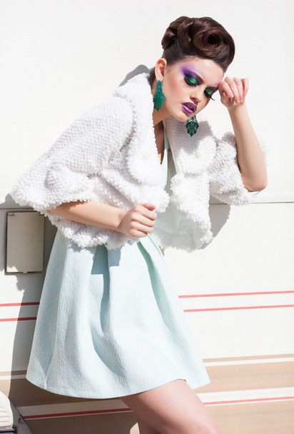 beautiful woman model in white dress, fur and high-heels posing outdoor - 写真・画像