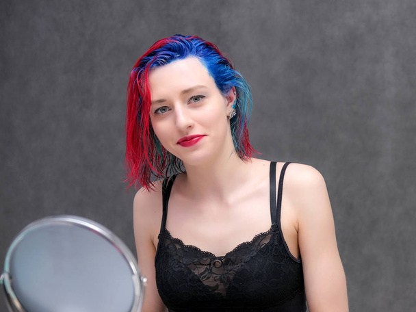 Portrait of a hairdresser makeup artist beautician. Model with red multi-colored hair. Head washing, hair dyeing, makeup application, hair styling. - Foto, immagini