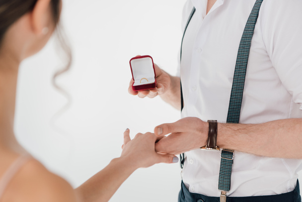 cropped view of man holding hand of young woman and making marriage proposal  - Fotoğraf, Görsel