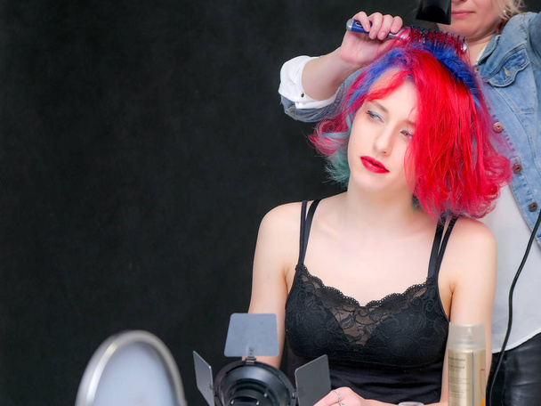 Portrait of a hairdresser makeup artist beautician. Model with red multi-colored hair. Head washing, hair dyeing, makeup application, hair styling. - Fotoğraf, Görsel