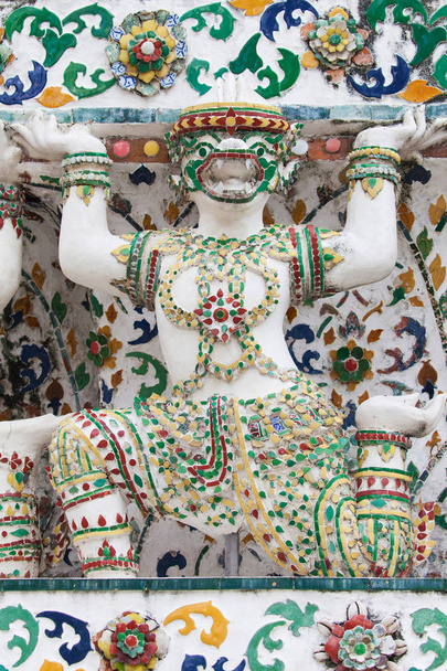 Estatua de un mono apoyando a un Prang en Wat Arun
 - Foto, imagen