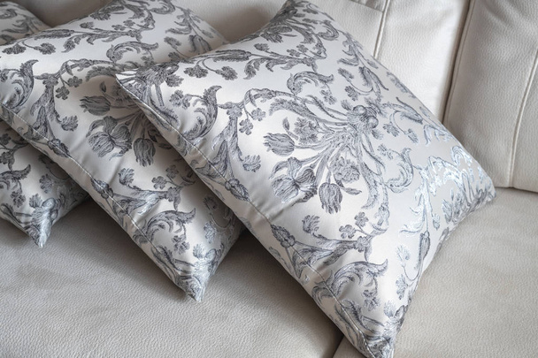 several patterned pillow on the light sofa - Fotó, kép