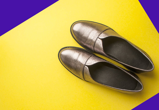 Pair of female shoes on yellow background. - Photo, Image