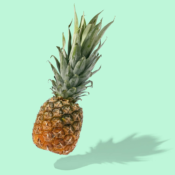Pineapple flies in the air on bright background creative layout, - Фото, зображення