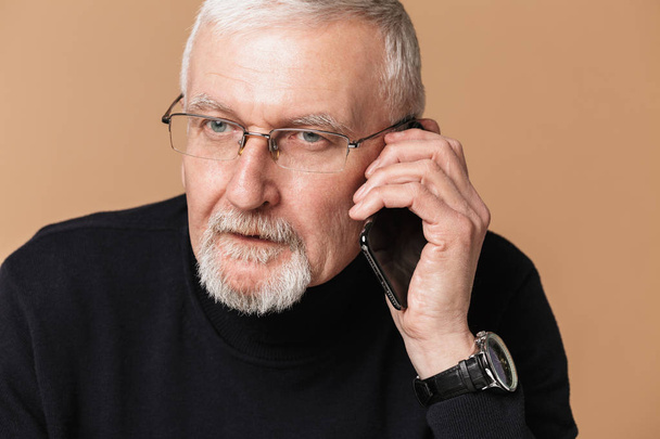 Old attractive man with gray hair and beard in eyeglasses and sw - Photo, Image