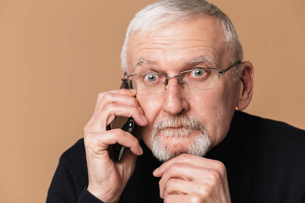 Old thoughtful man with gray hair and beard in eyeglasses and sw - Photo, Image