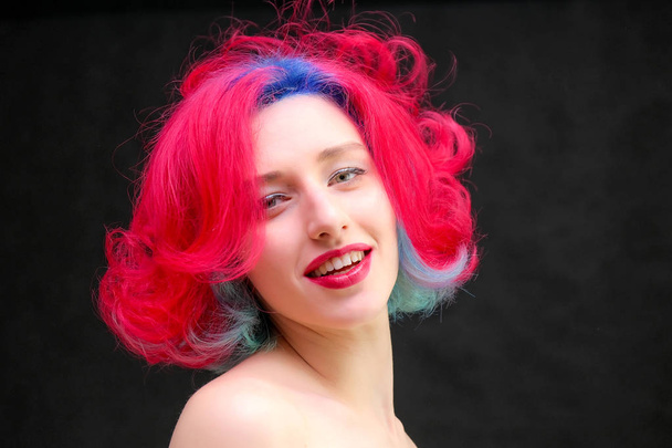 High fashion model woman with multi-colored hair posing in studio, portrait of beautiful sexy girl with a fashionable makeup and manicure. - Foto, immagini