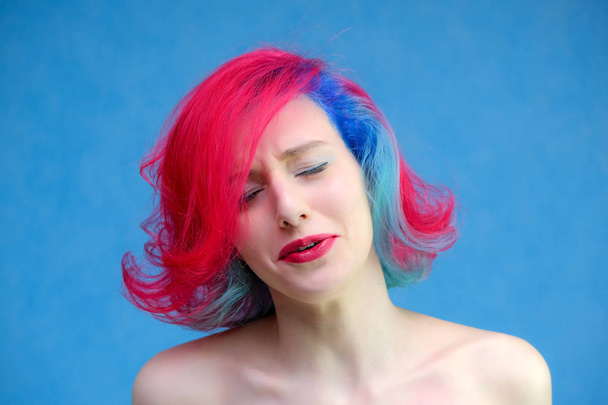 High fashion model woman with multi-colored hair posing in the studio, portrait of a beautiful sexy girl with a fashionable makeup and manicure. - Φωτογραφία, εικόνα