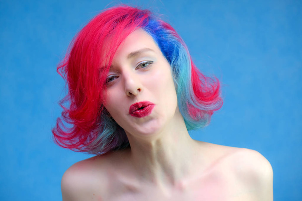 High fashion model woman with multi-colored hair posing in the studio, portrait of a beautiful sexy girl with a fashionable makeup and manicure. - Photo, Image