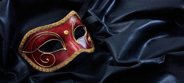 Carnival mask.  Venetian handmade mask on black satin  background, banner - Photo, Image