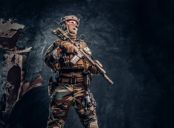 Elite unit, special forces soldier in camouflage uniform posing with assault rifle. - Photo, Image