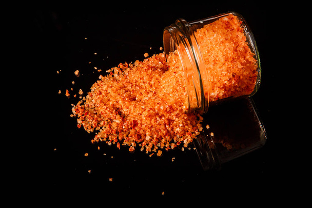 top view big orange organic sea salt poured out from small glass jar - Photo, Image