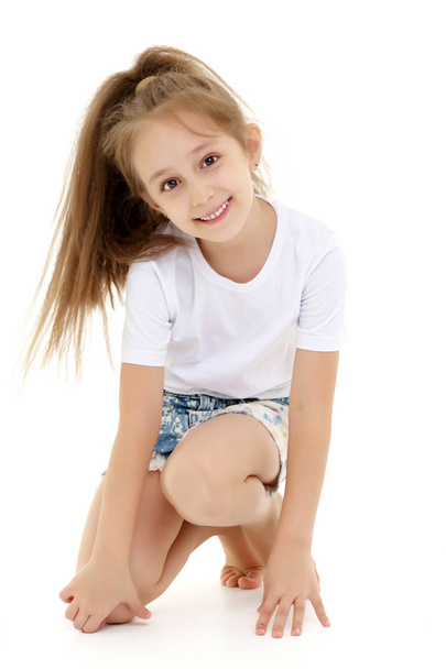 Little girl in a pure white t-shirt for advertising and shorts. - Foto, immagini