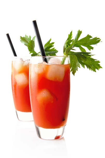 Bloody Mary with ice cubes with celery isolated on white - Фото, изображение