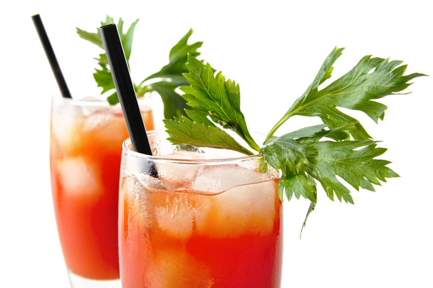 Close-up bloody mary with ice cubes with celery on white from above - Φωτογραφία, εικόνα