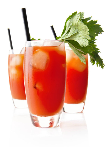 Three Bloody Mary with ice cubes with celery isolated on white - Foto, Imagen