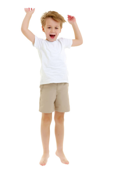 A little boy in a clean white T-shirt is jumping fun. - Foto, imagen
