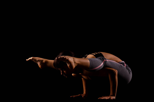 girl in shadows exercising yoga - Fotoğraf, Görsel
