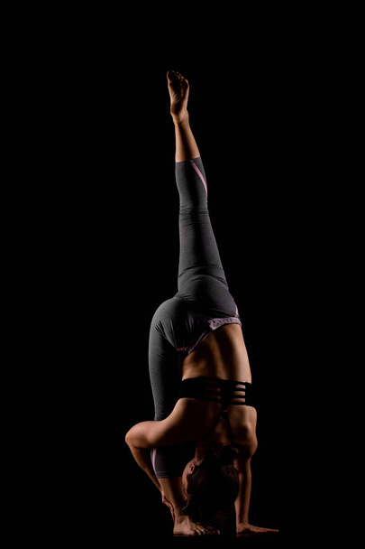 girl in shadows exercising yoga - 写真・画像
