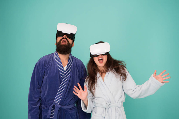 Future life. Good morning. Couple in love. Family. Virtual reality. Love. Happy family in vr glasses. Bearded man and woman in robe pajama. Future is now. Future technology. Vr glasses is our future - Photo, image