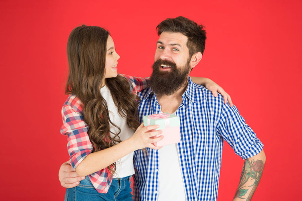 Happy fathers day. Man bearded father and cute little girl daughter on red background. Celebrate fathers day. Family values concept. Friendly relations. Father hipster and his daughter. Gift surprise - Photo, image