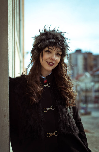 brunette wearing a fur hat outdoor - Fotó, kép