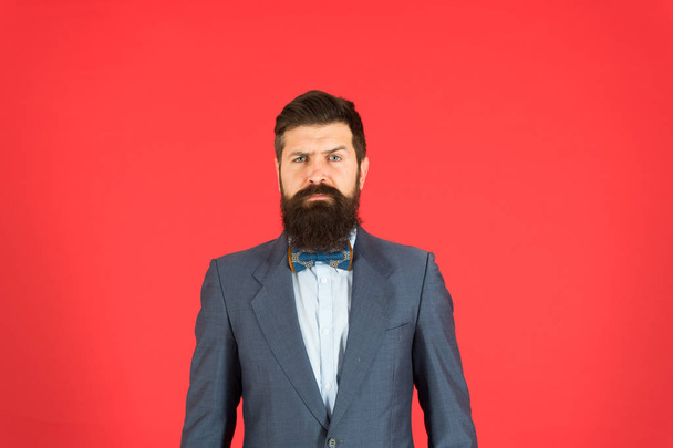 Classy style. Man bearded hipster wear classic suit outfit. Formal outfit. Take good care of suit. Elegancy and male style. Businessman or host fashionable outfit on red background. Fashion concept - Foto, Bild