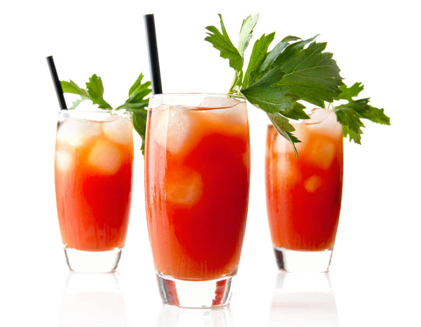 Red Bloody Mary drinks with ice cubes with celery isolated on white - Foto, afbeelding