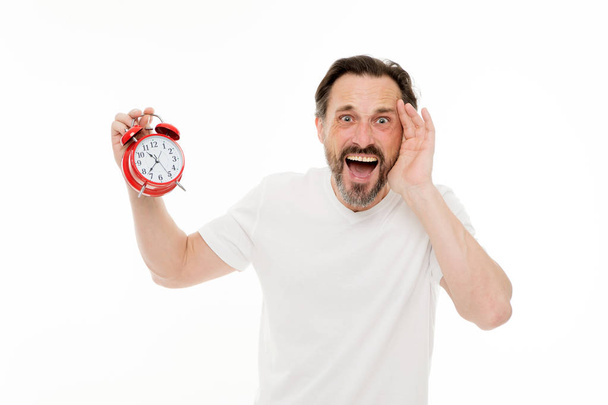 Stressful times. Man bearded mature guy hold clock isolated on white. Man with beard check what time is it. Time management skills. Personal schedule and daily regime. Alarm clock morning time - Foto, immagini