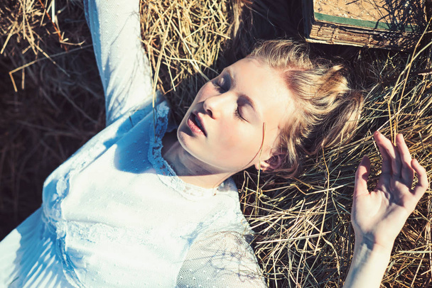 Albino girl sleep on hay. Woman with natural look and no makeup. Sensual woman with long blond hair. Beauty model with young face skin. Look and youth - 写真・画像