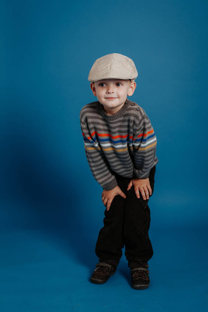 A little boy in a cap is posing and smiling. - Photo, image